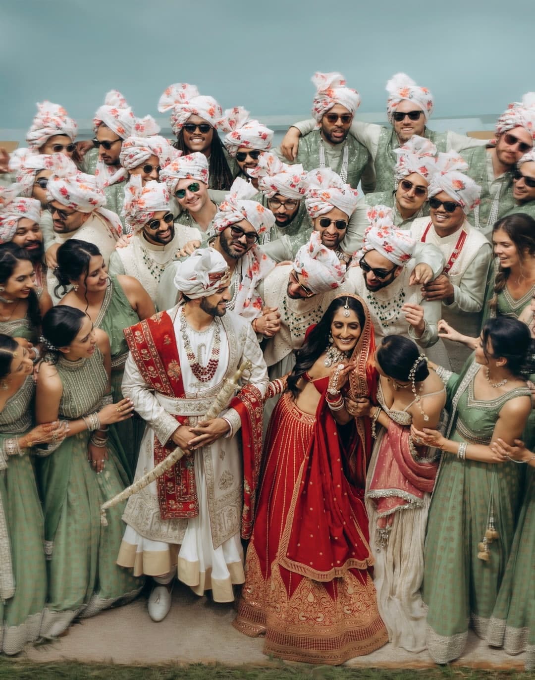 Coordinated bridal party in sage, cream, and red