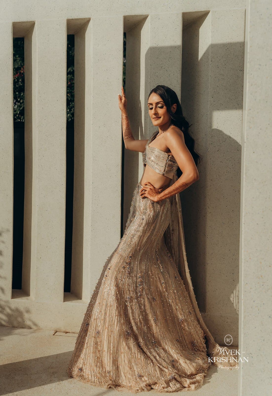 Champagne lehenga against modern architecture